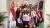 A group of students in Singapore for Westminster Working Cultures initiative surrounded by Singapore and Great British flags.