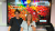 Research Associate Dr Louise Rondel and Professor Dr Emily Falconer standing in front of a screen displaying colourful fruit and vegetables and the text “Food and Taste Studies at Westminster.”