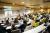 A back view of a lecture theatre full of students.