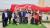 Students standing in front of a Coca Cola sign