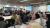 Attendees taking part in activities with post-it notes and posters on the tables