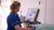 Photo of a nurse looking at scan images on a computer screen