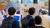 A group of school pupils are being shown a stand about Pharmacology Cell Biology.