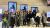 Group photo of JCDecaux group participants in front of advertising screens