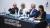 The four judges sit on the judging panel with a black tablecloth with white text reading: UNIVERSITY OF WESTMINSTER