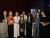 Professor Stroma Cole and and Women in Travel (CIC) Founder and Managing Director Alessandra Alonso pose alongside winners recognised across the other award categories, with several recipients holding their awards.