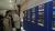 People observing photo display at the symposium