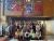 Group of Westminster students posing in front of a Google logo, in Google's Toronto offices.