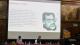 Speakers in person of the third panel with one of them doing a PowerPoint presentation