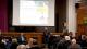 Dr Andreas Aresti giving a speech at the HM Prison Pentonville Celebration event pictured with the wider audience in front of the stage