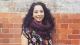 Portrait photo of Dr Ipshita Basu in front of a brick wall