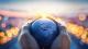 Stock photo of a globe being held in some hands.