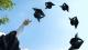 Student graduating hats in the air