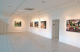 A Gallery room with walls and artwork hanging on them