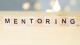 Mentoring word on wooden table