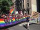 People holding Pride rainbow banners and flags