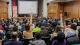 Photo of the audience at the What it takes to be Successful in Business event, raising hands to ask questions