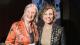 Professor Stroma Cole and Women in Travel (CIC) Founder and Managing Director Alessandra Alonso stand together at an event, with Cole holding an award.