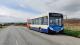 Stagecoach bus parking near a village on the side of the road in summer time