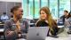 Two students smiling together in a classroom setting