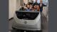 University of Westminster students sit in car dummy on automotive industry field trip in Germany