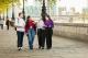 Group of four students walking along river thames