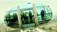 Photo of people in one of the cars of an observation wheel