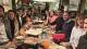 People gathered round table in restaurant at WBS alumni event