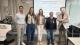 Group photo of all speakers at the workshop in front of a white board displaying the research project title. 