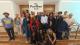 Group photos of attendees at the Beyond Borders event standing in front of a sign reading The Pavilion