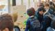 A group of students looking at a stand about plant biotechnology.