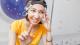 Woman with digital headwear equipment sensor connected to her ear, reading brain impulses.
