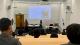 Two Westminster students delivering a Q&A to school pupils in a lecture room.