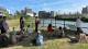 Picture of participants at the Common Stream session meditating on some grass next to the river