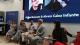Five people are seated on a panel discussion in front of a screen displaying the names Dr. Imad Guenane and Alvaro Caiza Infante. One speaker holds a microphone while others listen.