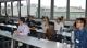 Students sitting down at long tables listening to someone speaking out of view at the Finance and Accounting Sympsosium