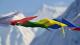 A row of flags with mountain backdrop