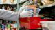 Person wearing gloves moving box of food at a food bank