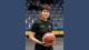 Frances Kremarik in her British Wheelchair Basketball referee kit and holding a basketball