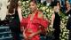 Gabrielle Thomas wearing a red waistcoat with large red beaded sleeves.