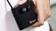 Hand holding a mini camera