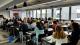 A talk is being delivered to a full room at the Rebel School x Netcompany workshop. 