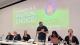 Ian Byrne MP stands up with a panel of speakers at the Right to Food conference. On the right hand side is Dr Sharon Noonan-Gunning. Behind them is a projector image of the Right to Food and University of Westminster logos with some info about the conference