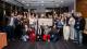 Group photo of attendees at the Ignite Fund celebration event. In the middle people are holding a large cardboard cheque.