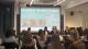 A photo of the panel in front of a projector reading INCLUSION IN TRANSPORT PLANNING with a description of the event.