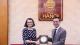 Katalin Illes posing for a photo with a Hanoi University staff member to mark the signing of the exchange agreement