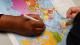 A line is being drawn on a world map to show the food miles involved in sending food to the UK.