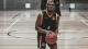 Action shot of student Michael Otoo playing basketball
