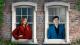 A man and a woman standing by window