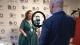 Dr Regina Murphy Keith being interviewed at the WHA. In front of her is a ring light and a phone filming the interview, as well as the interviewer. 